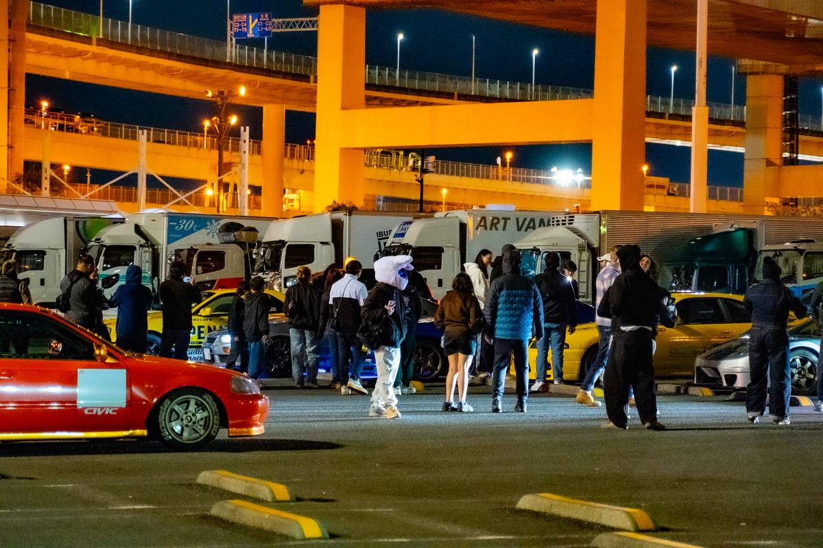 Crowd of car enthusiasts at Daikoku PA Tokyo at night