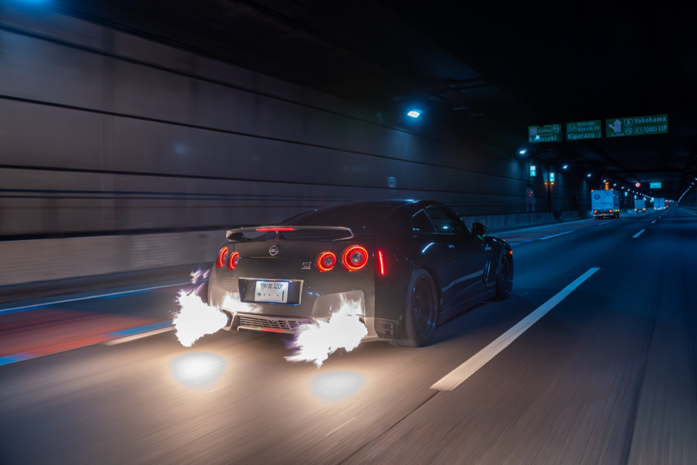 Nissan GT-R R35 shooting flames in a Tokyo expressway tunnel — the kind of shot content creators come for