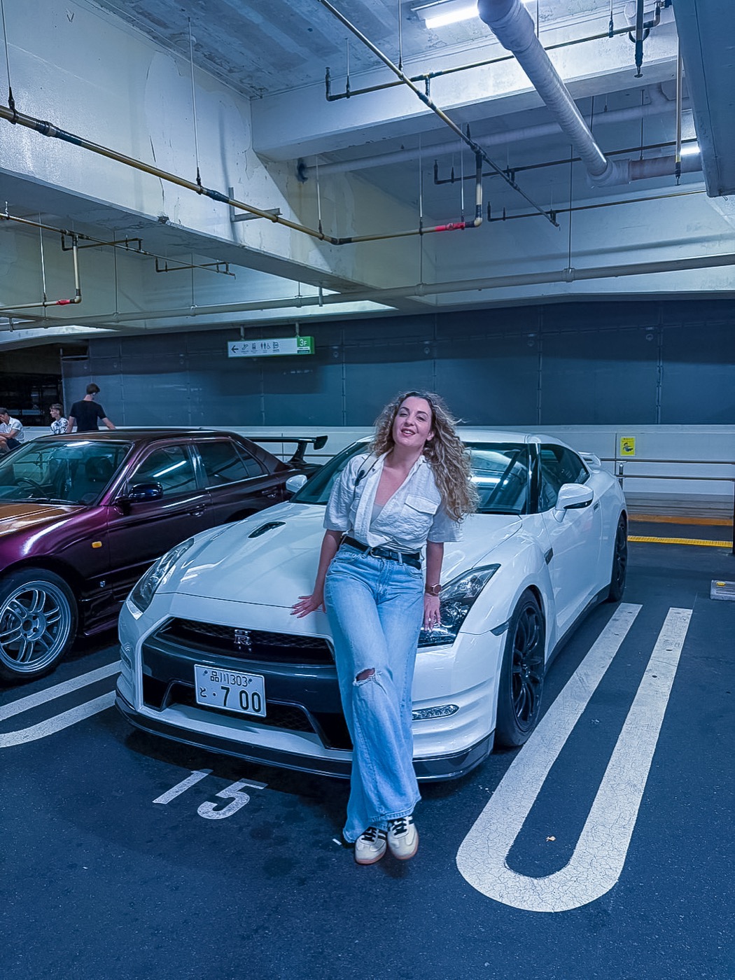 Guest with a white Nissan GTR R35 in a Tokyo parking garage before heading to Daikoku PA
