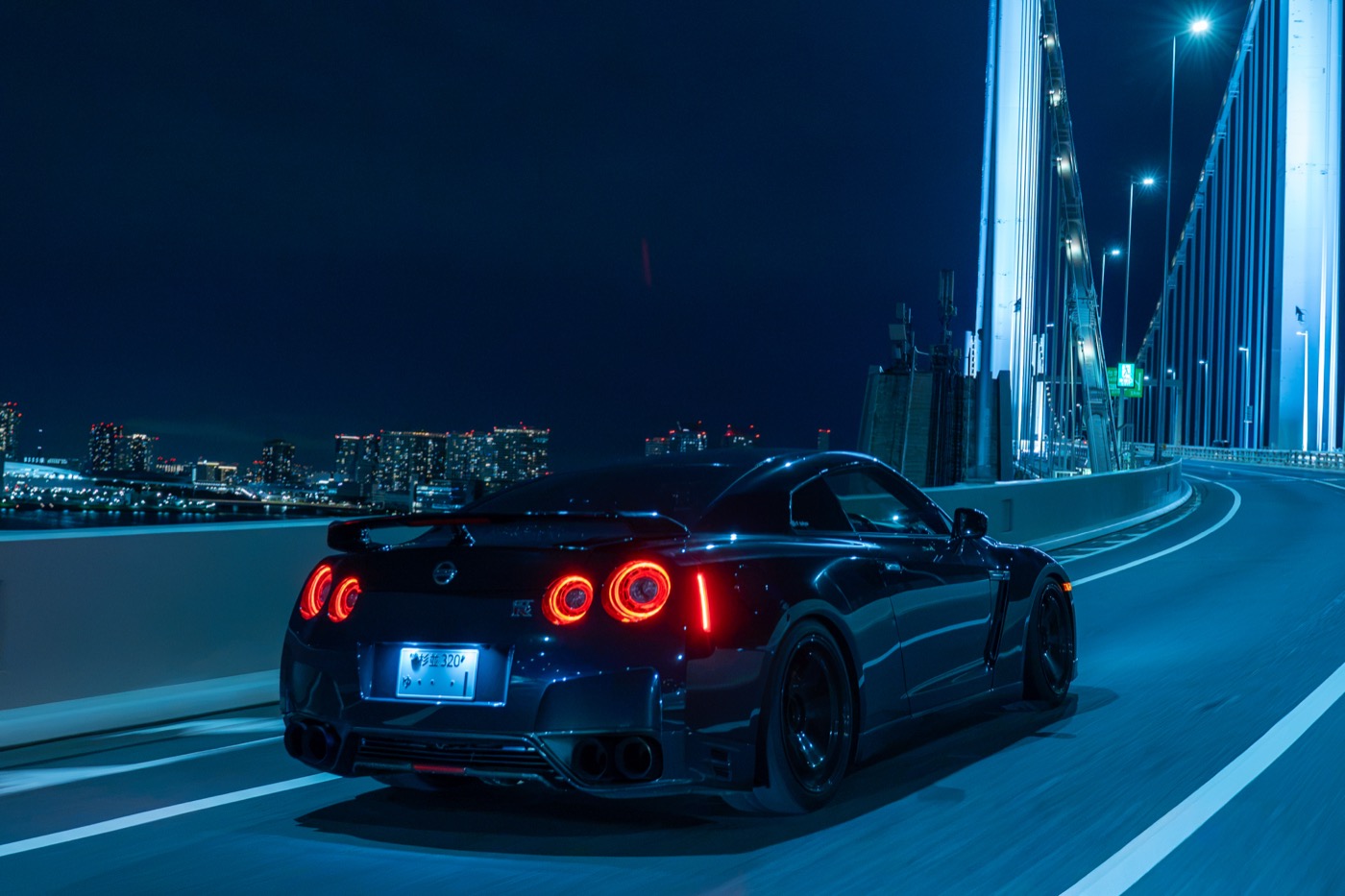 Nissan GT-R R35 crossing Rainbow Bridge — a signature Tokyo shot